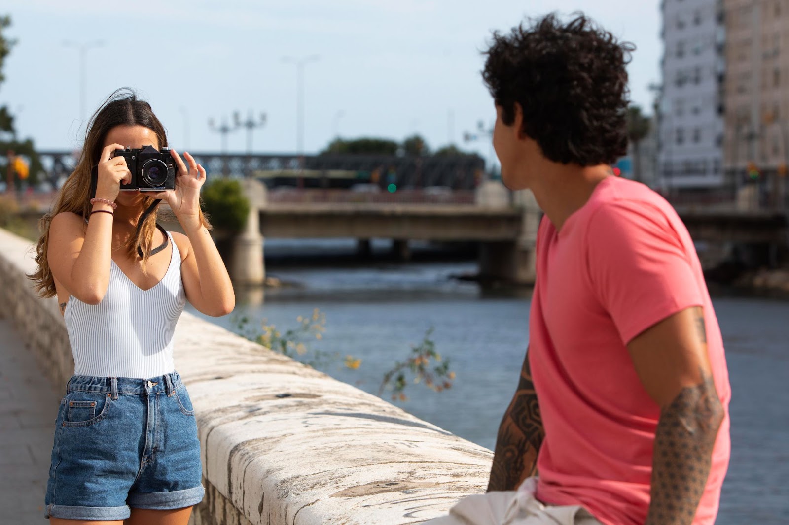 A fashion photographer capturing a model in an outdoor setting