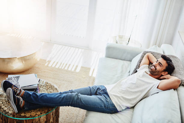 Man relaxing comfortably on couch