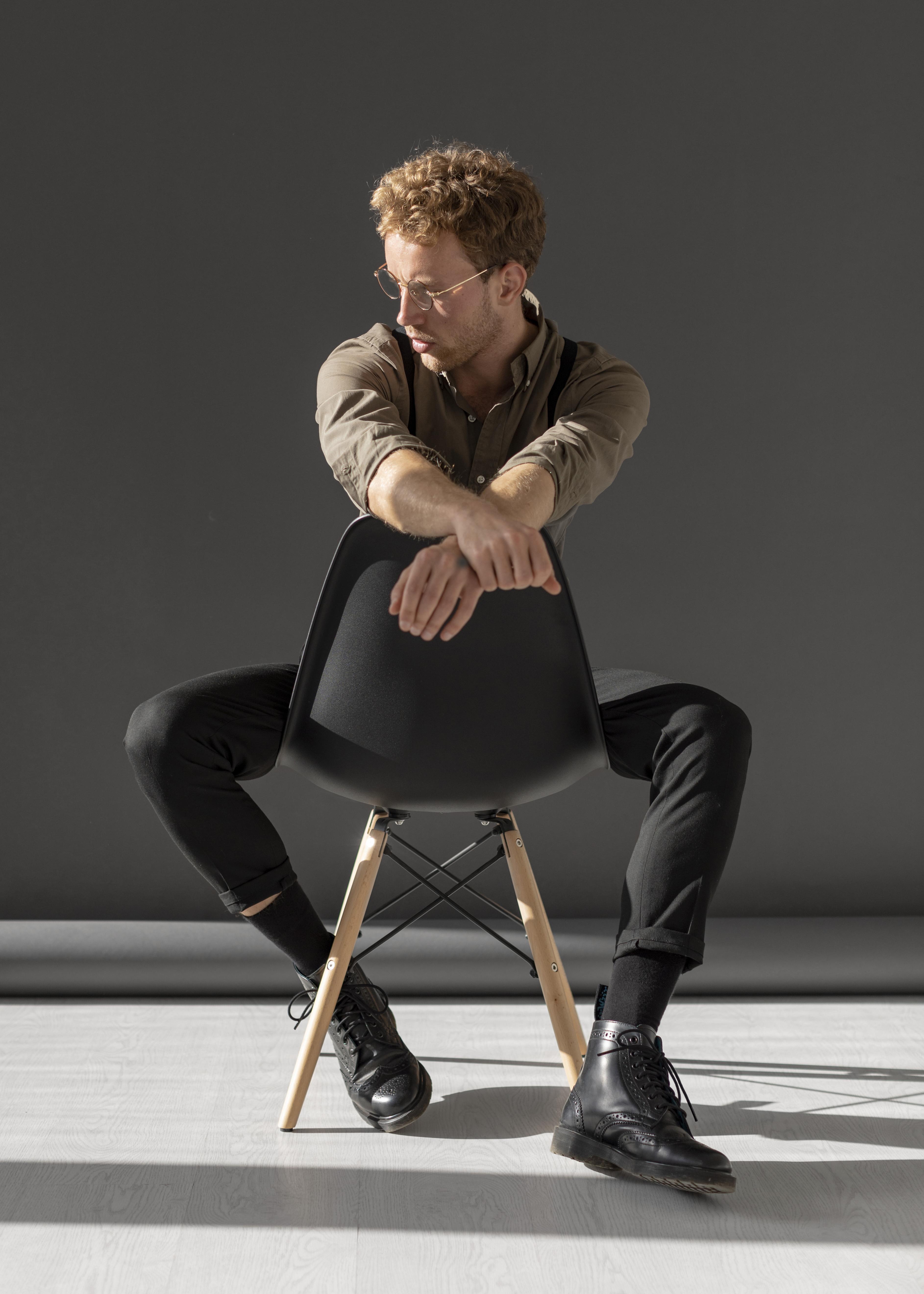 Man sitting backward on chair