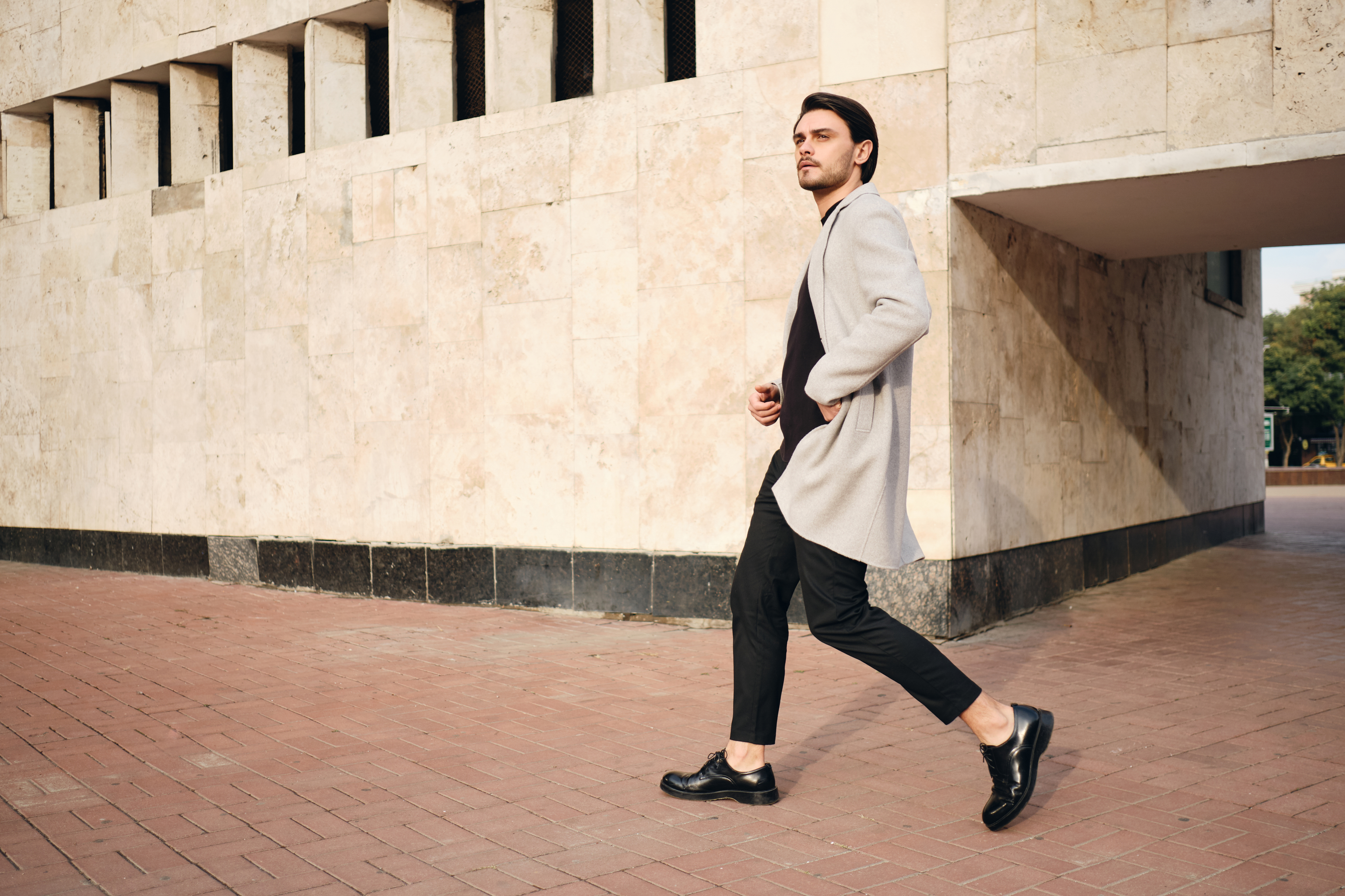 Stylish man walking urban street