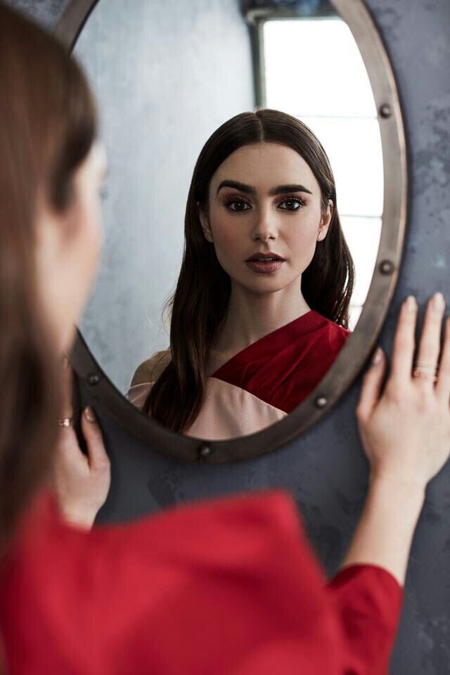 Model looking at the camera through a mirror 