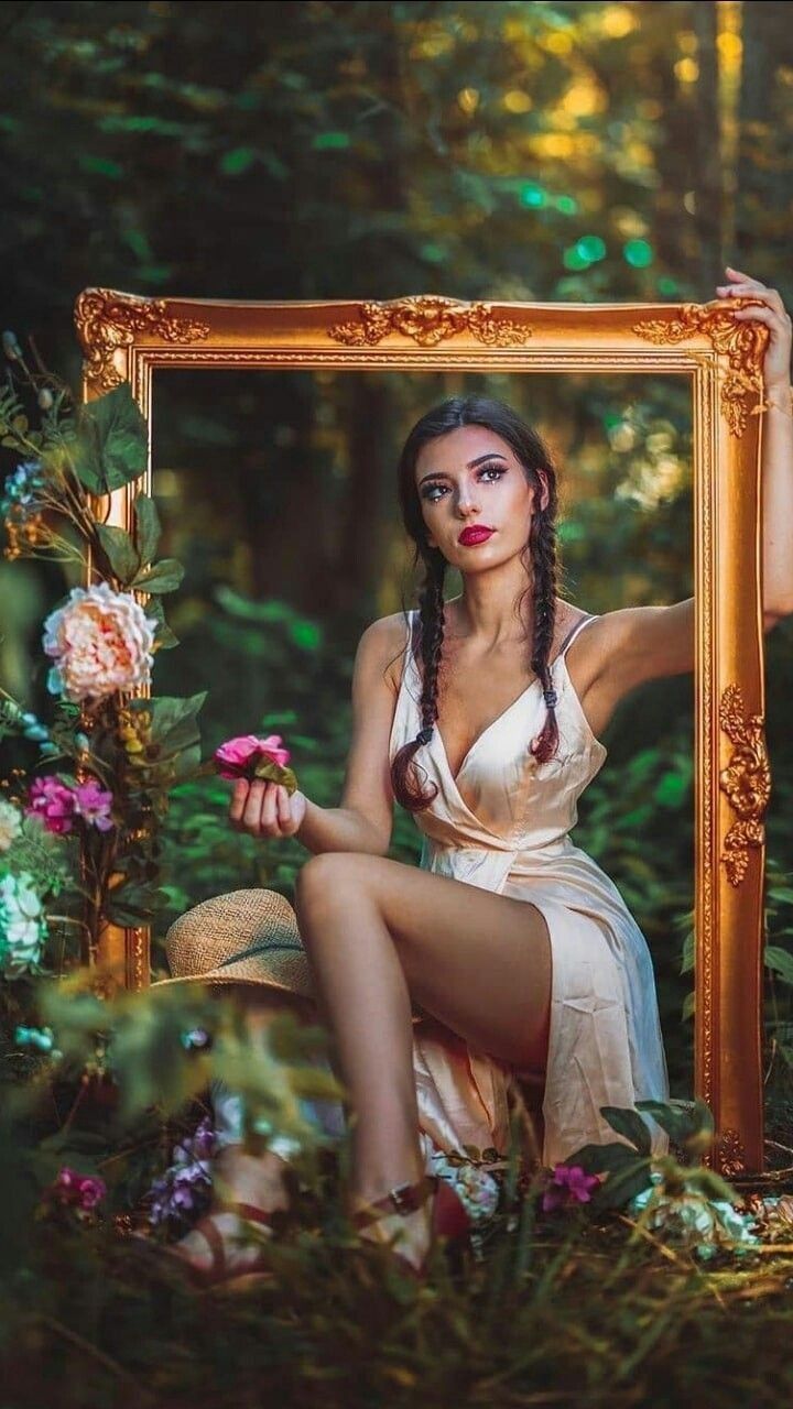 Model posing while holding a frame 