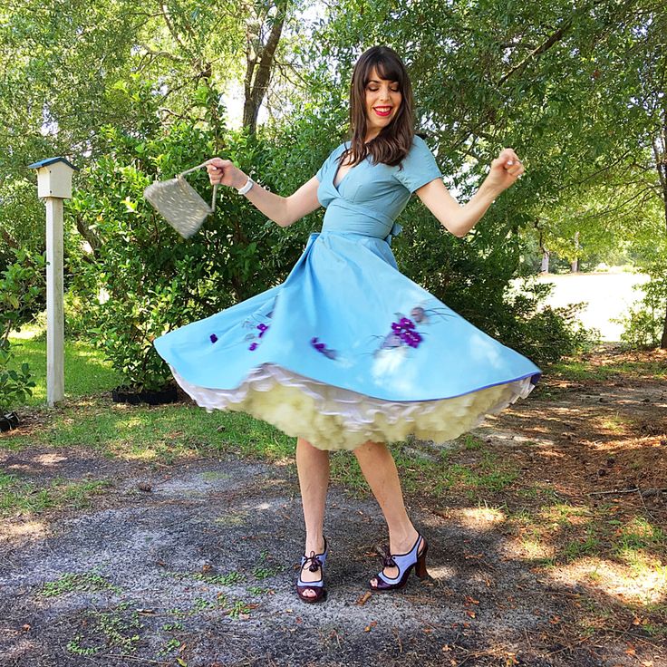 Model twirling amid greenery