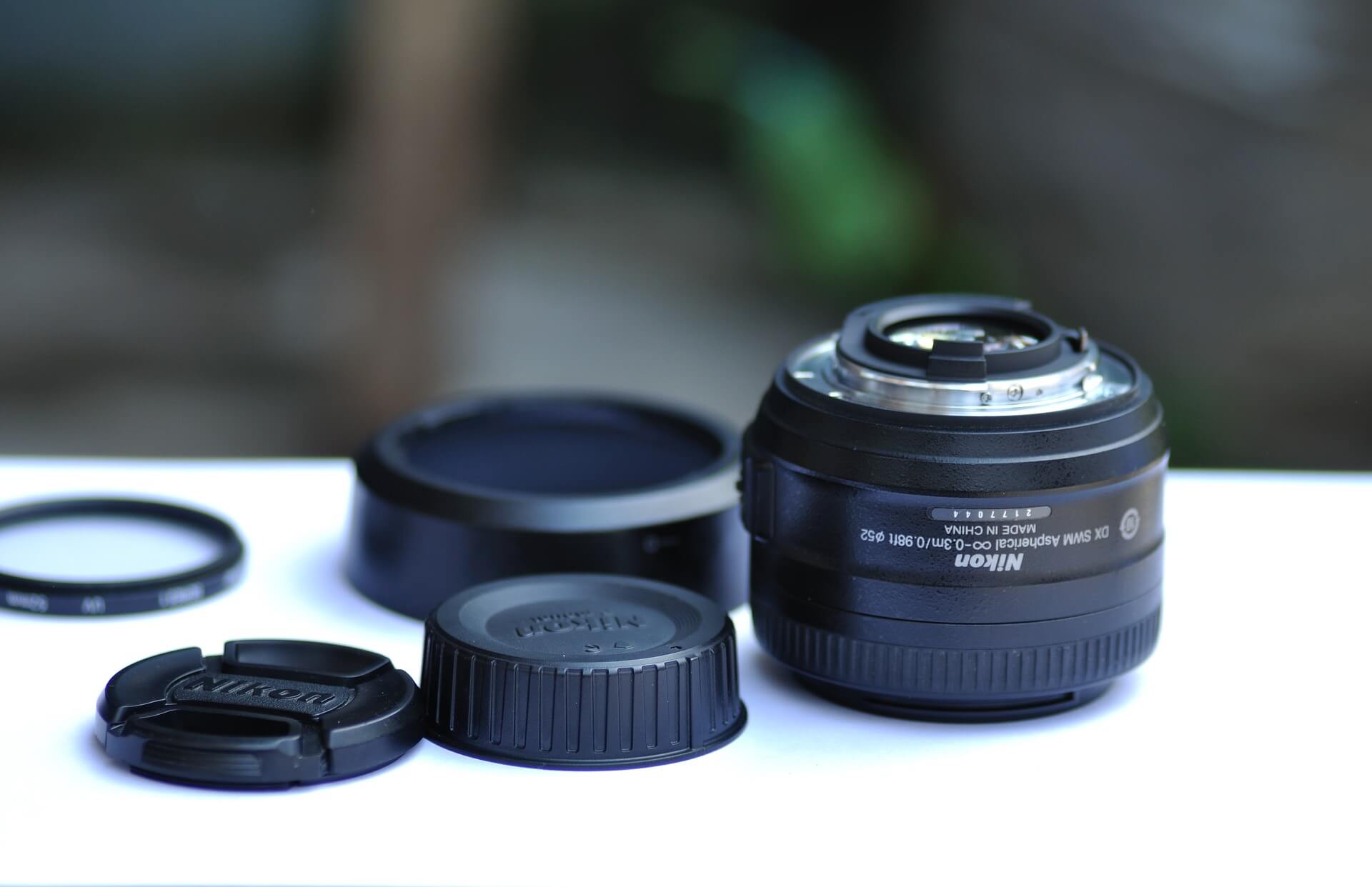 Close-up of a Nikon camera lens with accessories