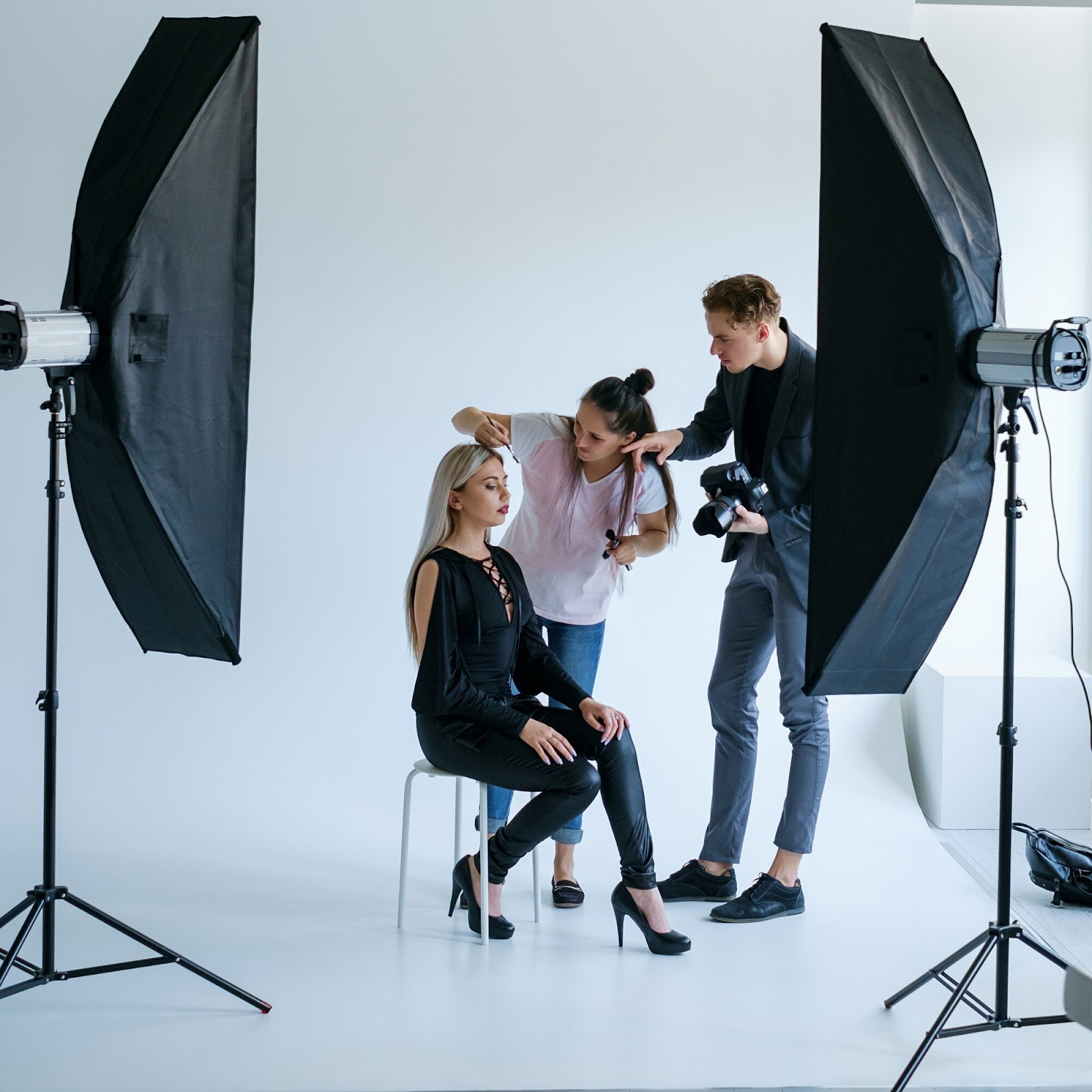 Model, makeup artist, and photographer in a photoshoot setting