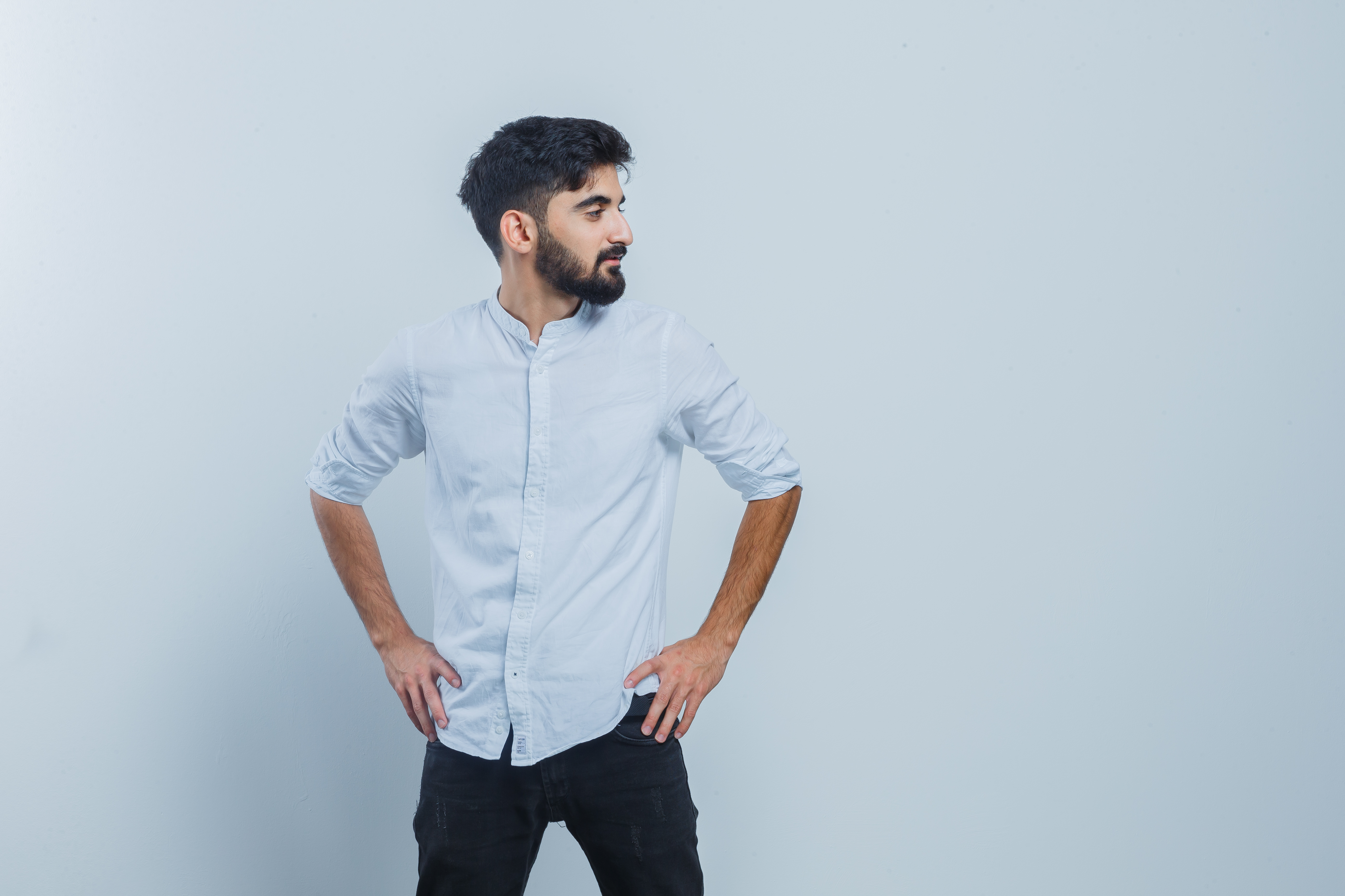 Casual man standing with hands-on-hips