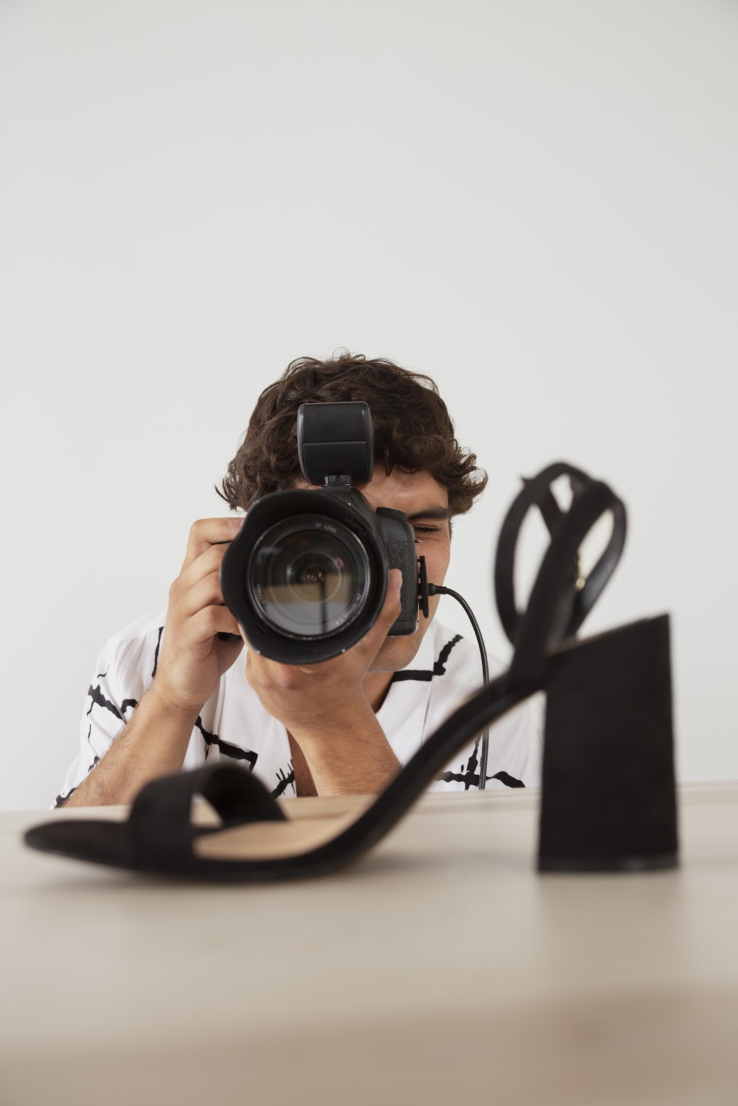 A photographer taking a footwear photo 