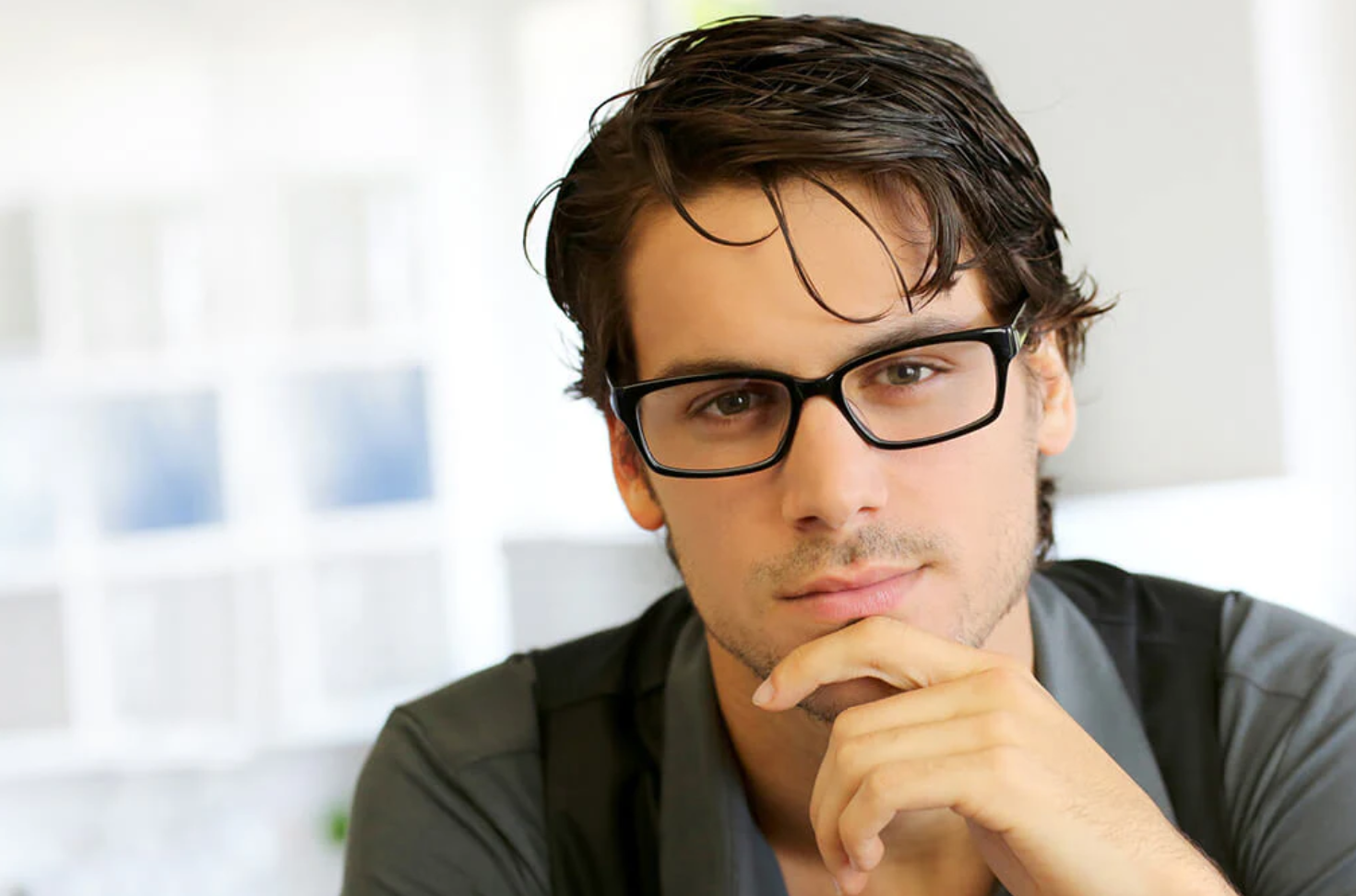 Thoughtful man wearing stylish glasses